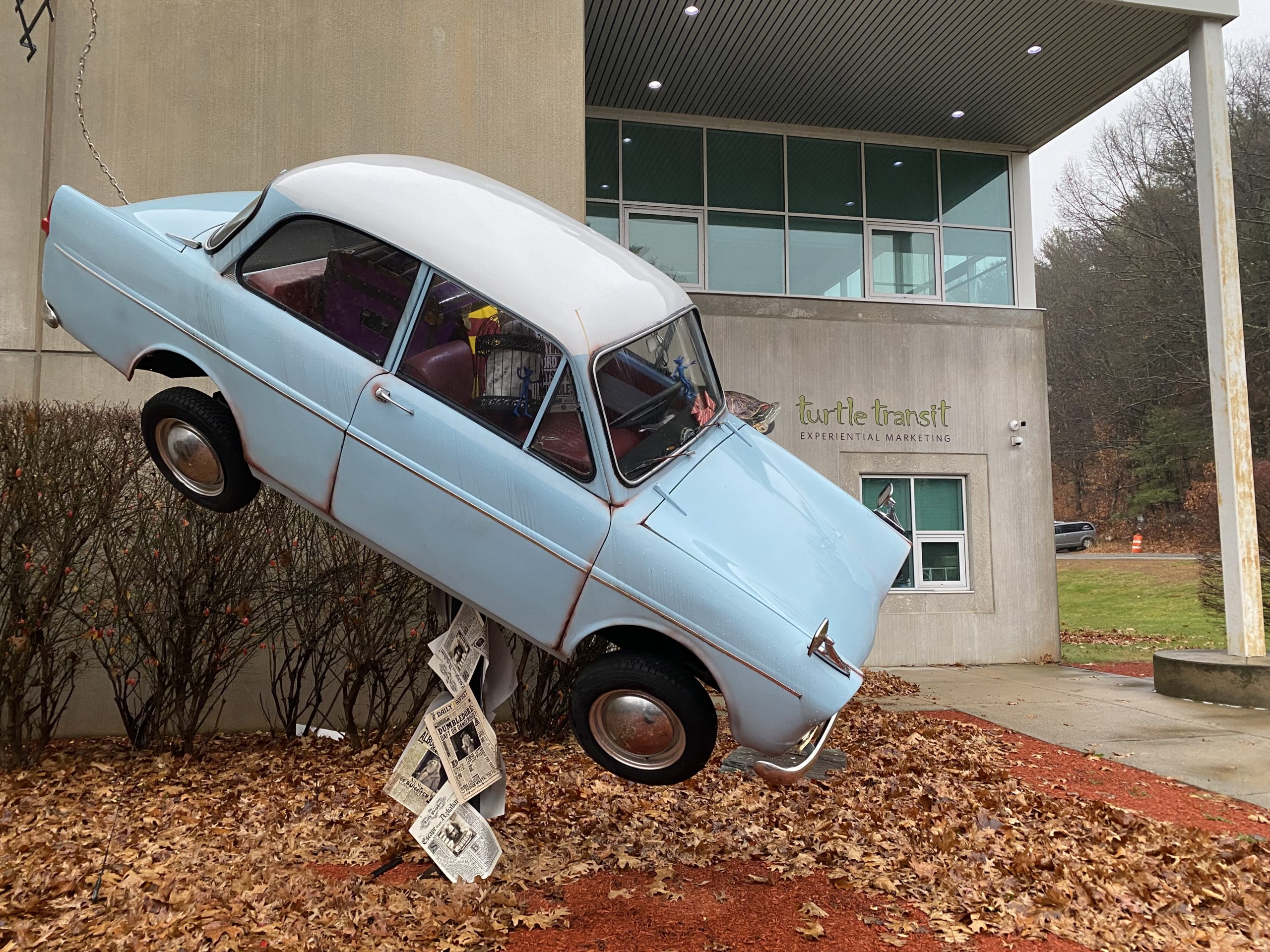 A light-blue vintage Ford Anglia fabricated to resembl e the flying car from the Harry Potter movies is on display in front of the Turtle Transit headquarters in Massachusetts.
